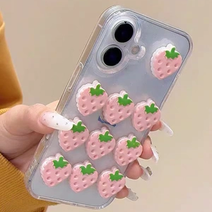Detail of clear iPhone case with 3D pink strawberry charms and sparkling glitter effect