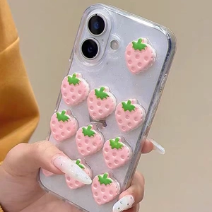 Detail of clear iPhone case with 3D pink resin strawberries and glitter finish