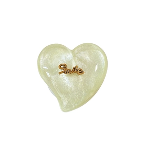 Support de téléphone cœur pailleté avec écriture Smile dorée en finition jaune nacré
