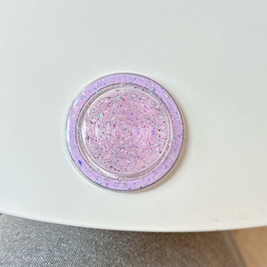Macro shot of purple glitter resin MagSafe phone grip with sparkling round finish