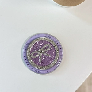 Close-up of purple rhinestone bow phone grip with Gift For You text and star icons