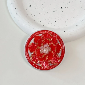 Macro shot of red flower phone socket with gold edges and crystal center on a white base