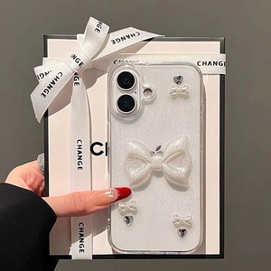 Detail of glitter iPhone case with 3D pearl bows and heart charms in a premium gift box