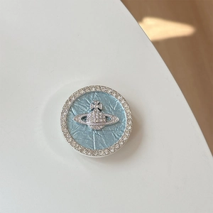 Close-up of rhinestone planet phone grip with light blue texture and crystal accents