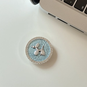 Macro view of blue leather phone socket featuring a rhinestone-studded silver balloon dog