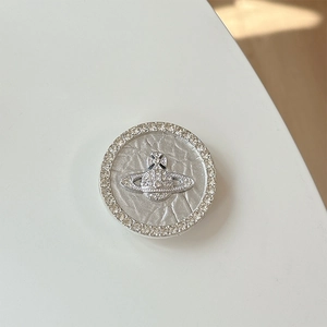 Detail of silver rhinestone saturn phone grip with sparkling crystal and alloy textures