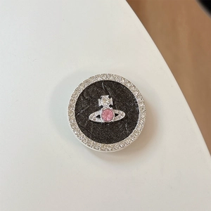 Detail of glittery planet phone grip with rhinestones and pink crystal orb logo