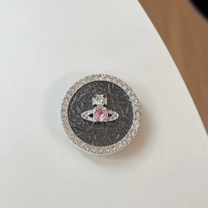 Detail of a sparkling rhinestone planet phone socket with pink gem and marble texture