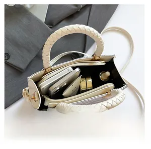Internal view of beige crossbody bag showing spacious capacity and organized pockets