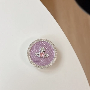 Detailed macro view of rhinestone phone grip with purple texture and orb logo design