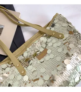Detail of sequin tote bag with Creative Cat leather logo and metallic gold finish