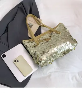 Detailed size comparison of the gold sequin tote bag with a tablet and smartphone