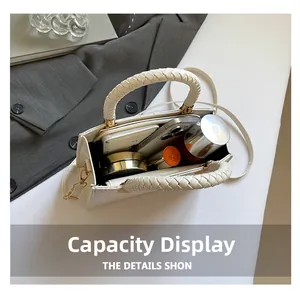 Detail view of large interior capacity for daily essentials in cream leather handbag
