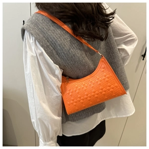 Detail of orange hobo bag with geometric quilted texture and sleek metal zipper closure
