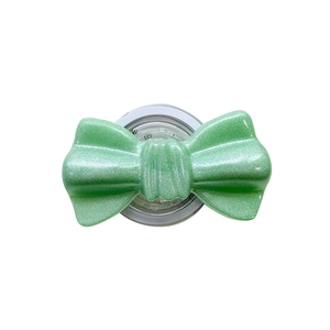 Magnetic glitter green bow phone grip stand with shimmering finish on white background