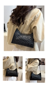 Macro detail of black quilted crescent bag with refined embossed rhombus texture