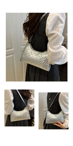 Detailed close-up of the silver quilted underarm bag with textured rhombus stitching