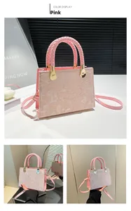 Detailed view of pink tote bag featuring embossed texture and woven leather handles