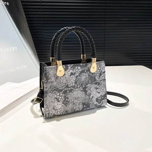 Modern oriental pattern square handbag with black woven handle and golden hardware