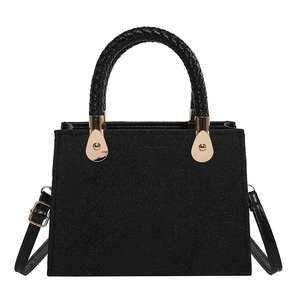 Elegant black embossed leather shoulder bag with woven handle and gold drop buckle