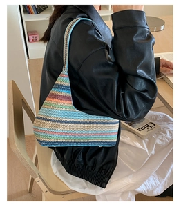 Detail of bohemian rainbow crochet tote bag showing woven texture and blue handle
