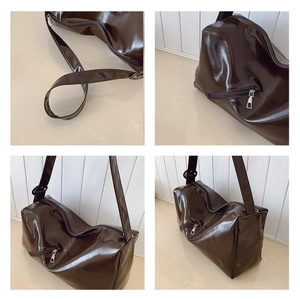 Detail view of coffee brown glossy tote bag with metal buckle and side zipper pocket