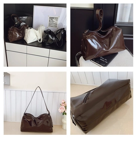 Detail of glossy oil wax leather tote showing the metal zipper and shiny texture