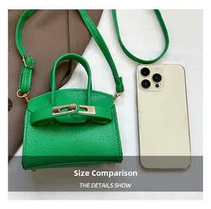 Mini green leather handbag size comparison with smartphone showing compact dimensions