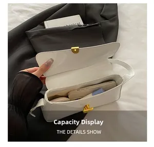 Detailed interior view of white patent leather shoulder bag showing storage capacity