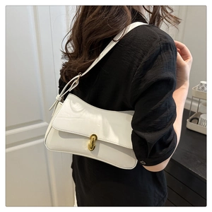 Detail of white leather shoulder bag with elegant gold-tone metal twist lock closure