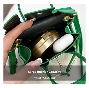Green leather mini bag interior showing capacity for makeup and wireless earbuds