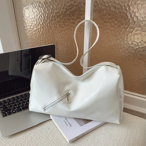 Minimalist white leather tote bag with zip detail on scene with laptop and books