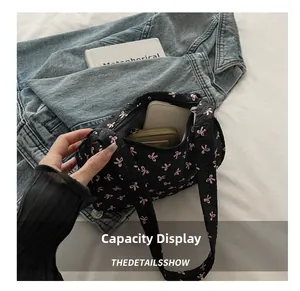 Interior view of black quilted shoulder bag with pink bows showing large capacity