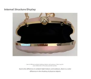 Detail of the pearlescent pink shell clutch bag with pearl clasp and internal lining