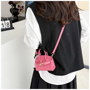 Detailed side view of a pink litchi grain mini bag with metal clasp and thin strap