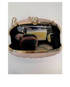 Pink shell evening clutch bag interior showing space for phone and makeup accessories