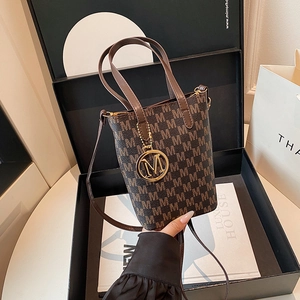 Retro monogram bucket bag in dark brown with gold M-pendant and leather straps