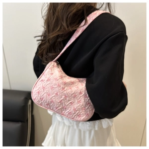 Detailed close-up showing pink 3D floral embossed texture and ribbon bow on handbag