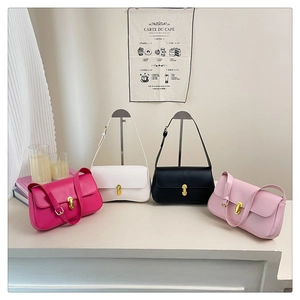 Detailed view of four elegant leather shoulder bags with gold metal swivel locks
