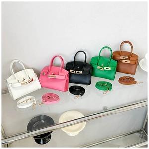 Detailed display of five colorful mini handbags with litchi pattern and metal clasp