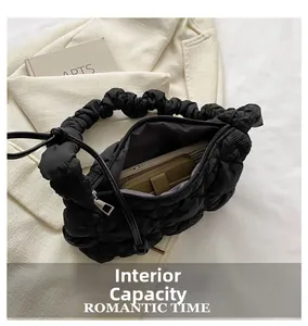 Detail view of small quilted puff bag interior showing spacious storage capacity