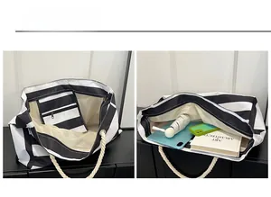 Detail view of large striped tote bag with cotton rope handles and interior zipper pocket