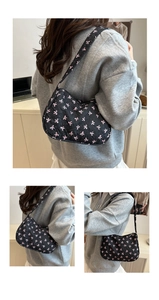 Detail of black quilted shoulder bag featuring pink embroidered bows and texture