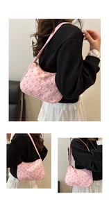 Close-up of pink shoulder bag with embossed bow texture and stylish fabric strap