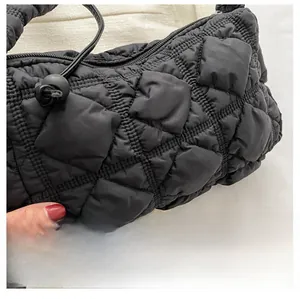 Close-up of black quilted nylon fabric with puffy texture and drawstring detail