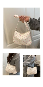 Detail view of white quilted shoulder bag with pink bow patterns and top zipper closure
