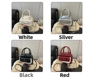 Detailed view of dumpling bags with bow and lace trim in white, silver, black, and red colors