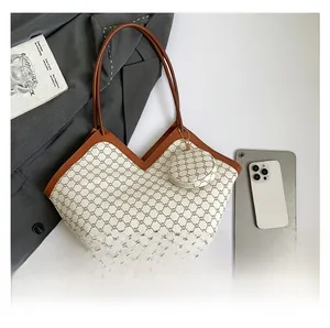 Close-up of vintage check pattern tote bag with V-shaped opening and matching round charm
