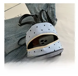 Detailed view of the mini backpack interior showing space for a smartphone and items