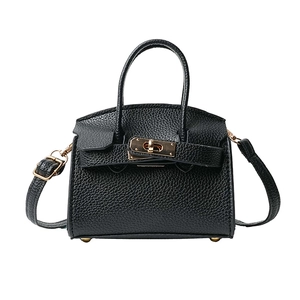Mini black lychee leather crossbody bag with top handle and gold twist-lock hardware